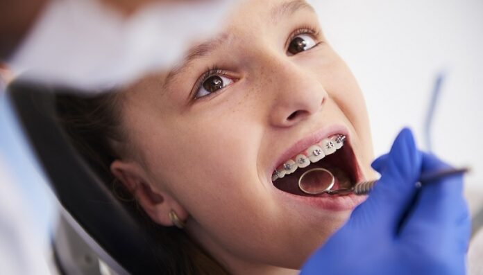 Girl with braces during a routine, dental examination
